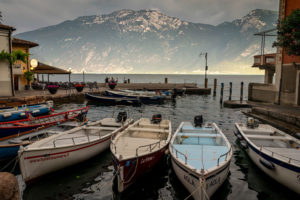 Fishing boats moored in the harbour of Limone sul Garda on the shore of Lake Garda