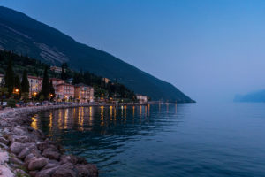 Twilight view of lakeside hotels in Torbole, Lake Garda, Italy